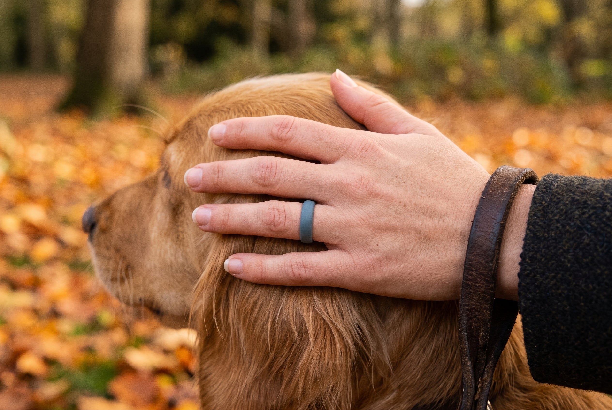 Charcoal women's silicone ring worn stroking a dog on an autumn walk on Hampstead Heath