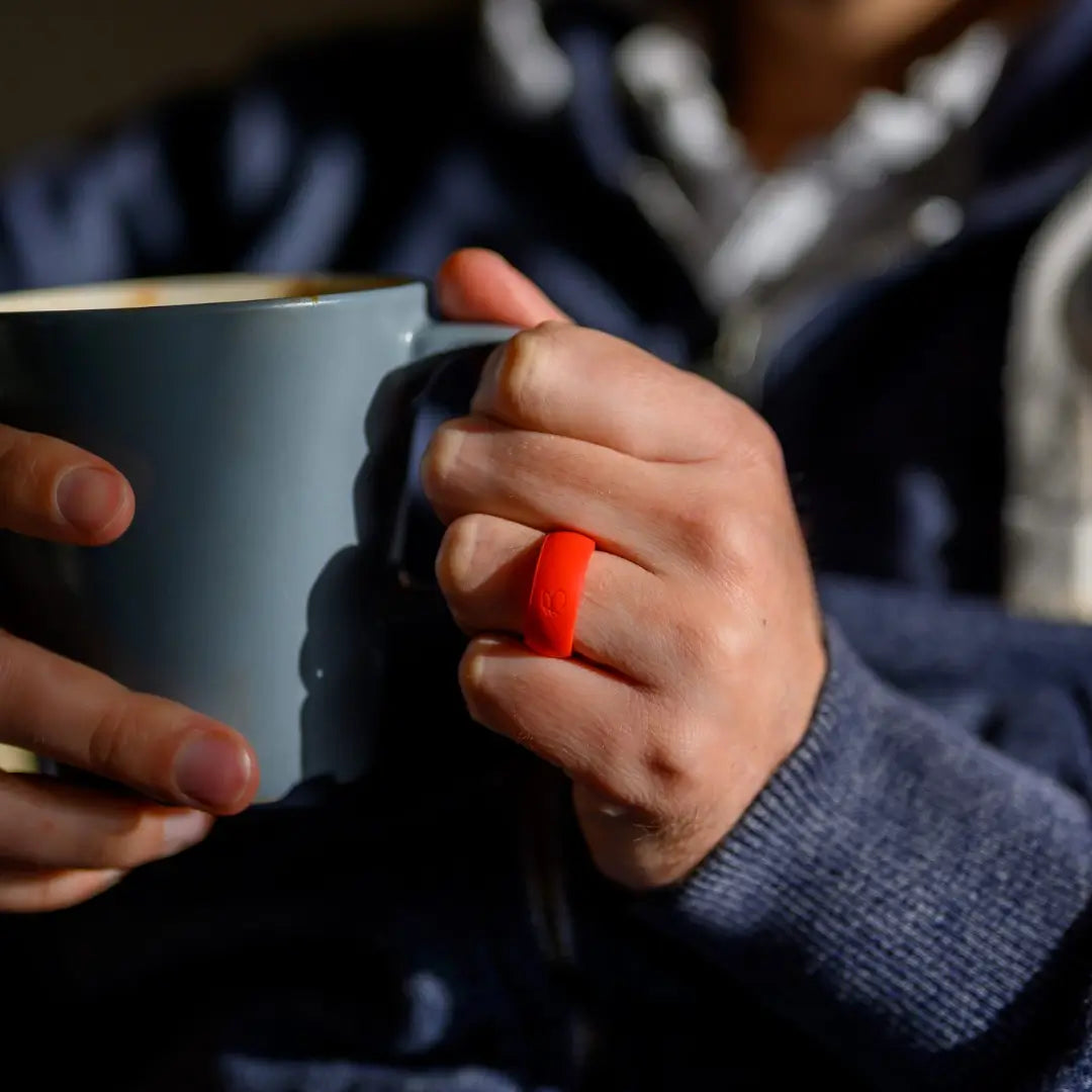 man wearing botthms red silicone ring while drinking