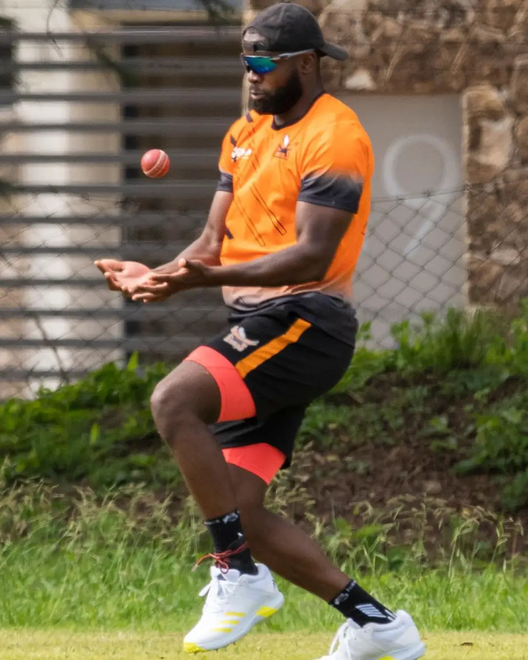 man playing cricket wearing botthms grip socks and sport t-shirt