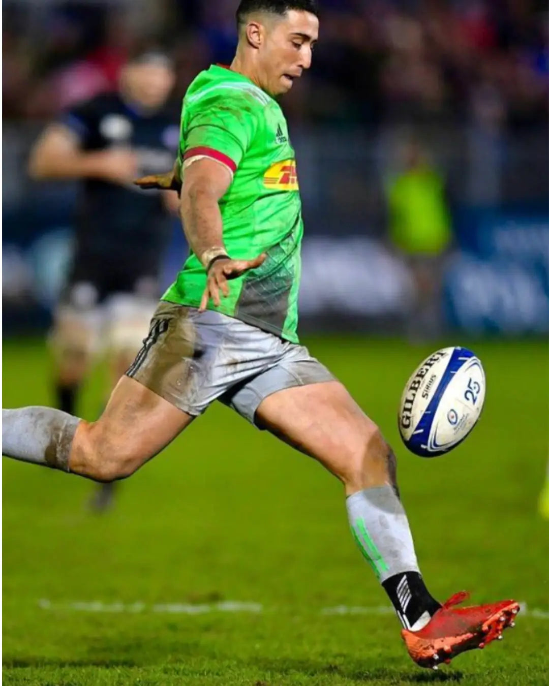 athlete playing rugby with botthms grip socks