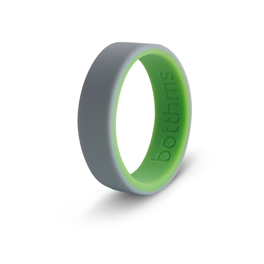Two-tone men's silicone ring, grey outer with bright green inner, angled view