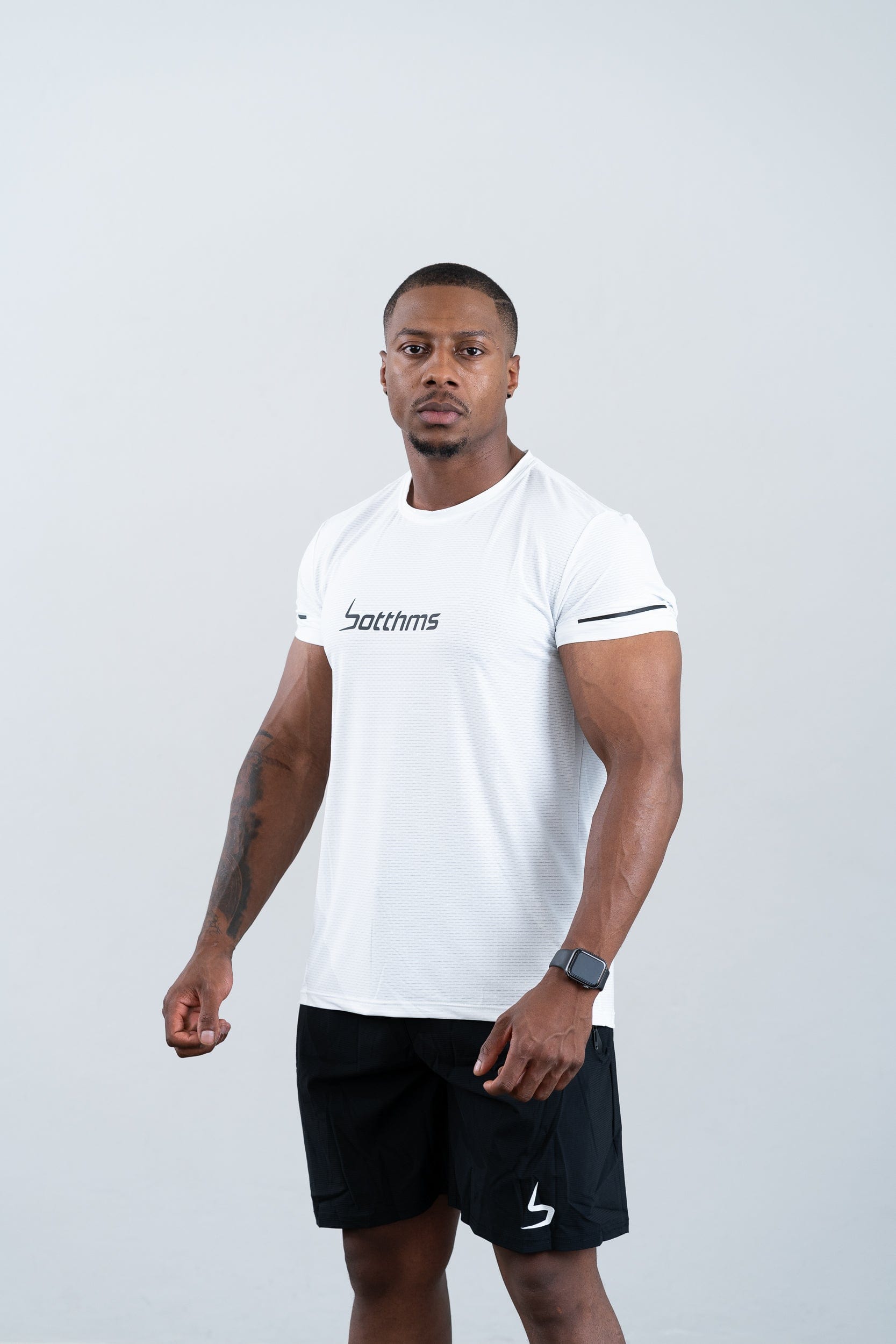 athlete wearing botthms white sport t-shirt - front left view