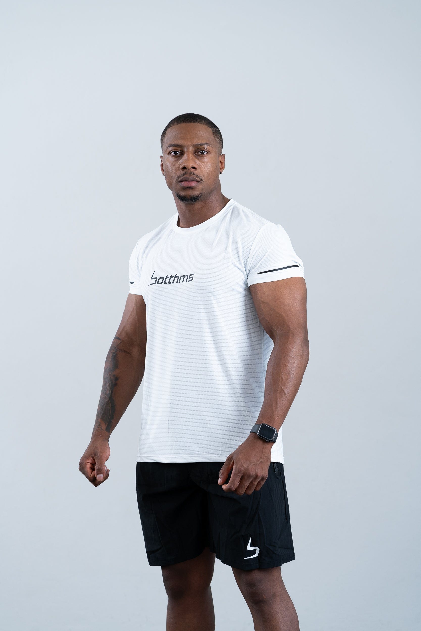 athlete wearing botthms white sport t-shirt - front left view