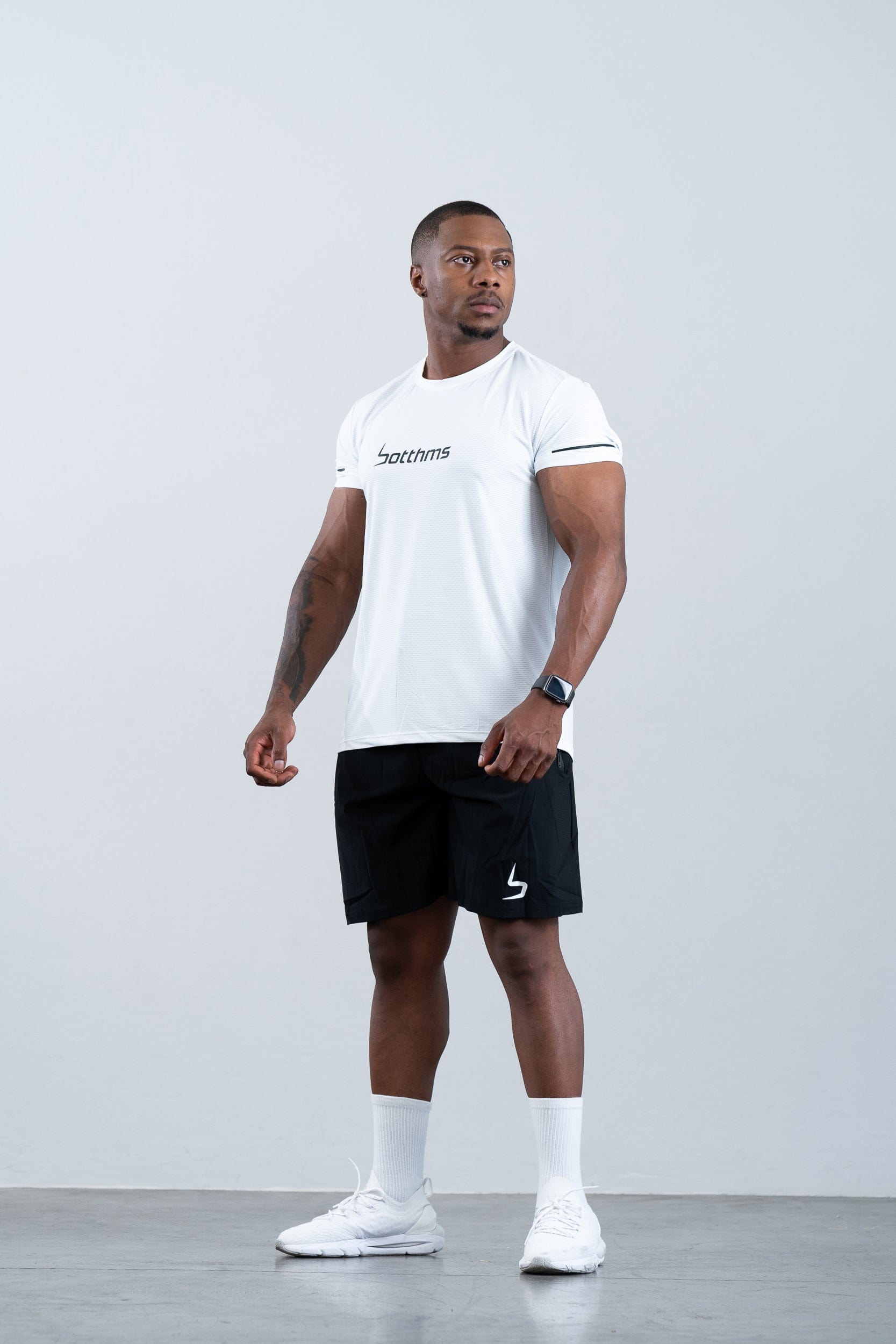 athlete wearing botthms white sport t-shirt and socks - front left view full