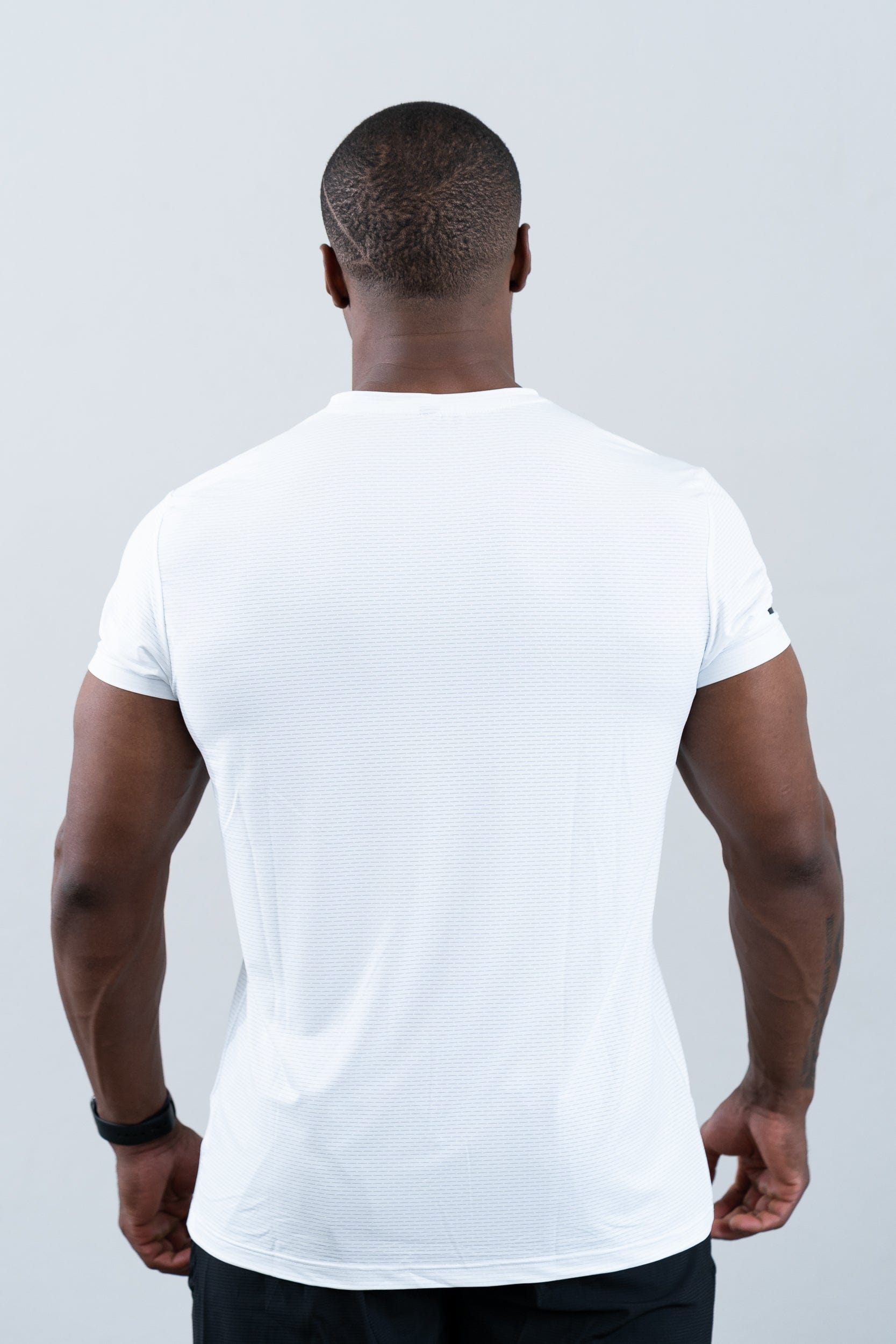 athlete wearing botthms white t-shirt - clear rear view