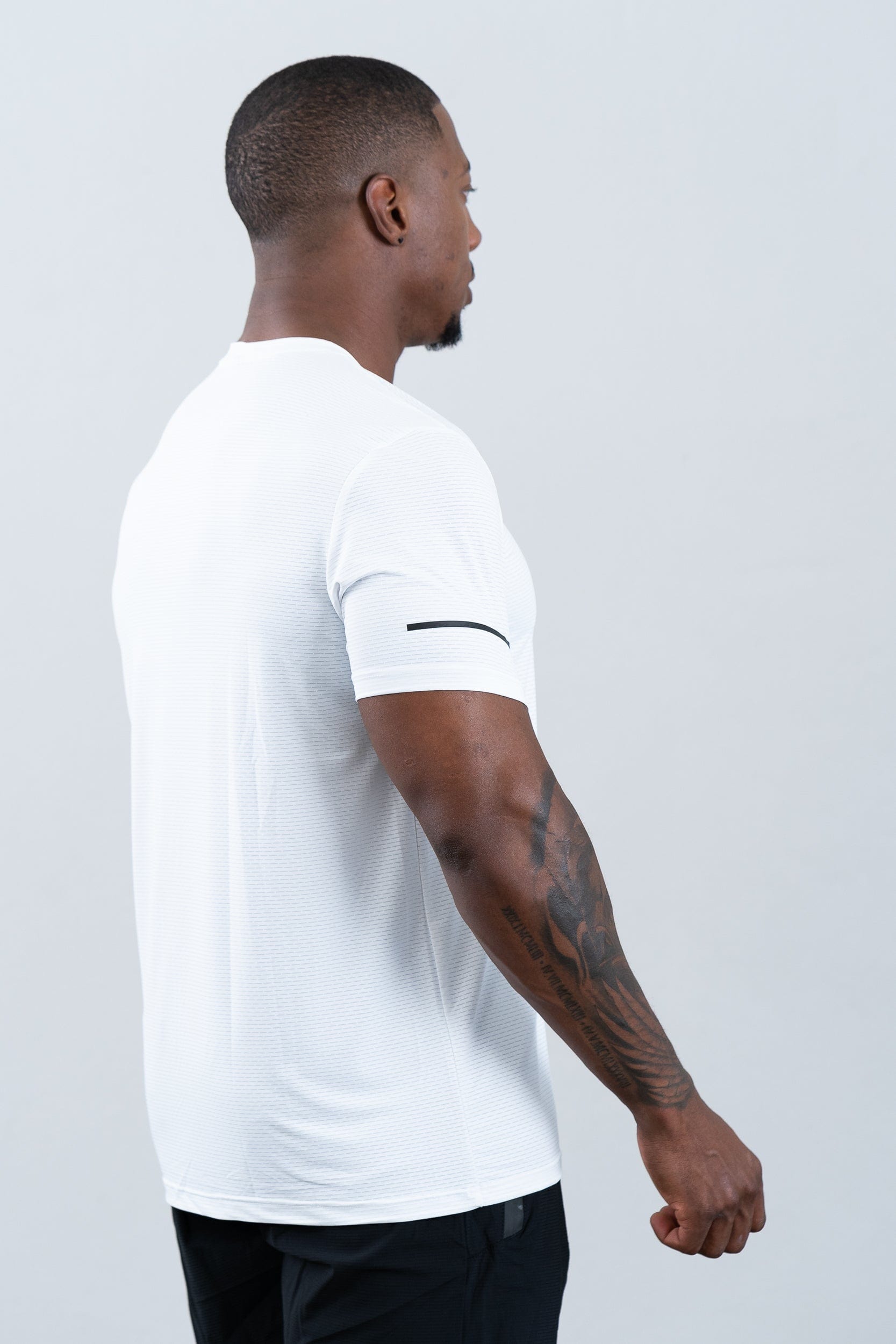athlete wearing botthms white sport t-shirt - rear right view