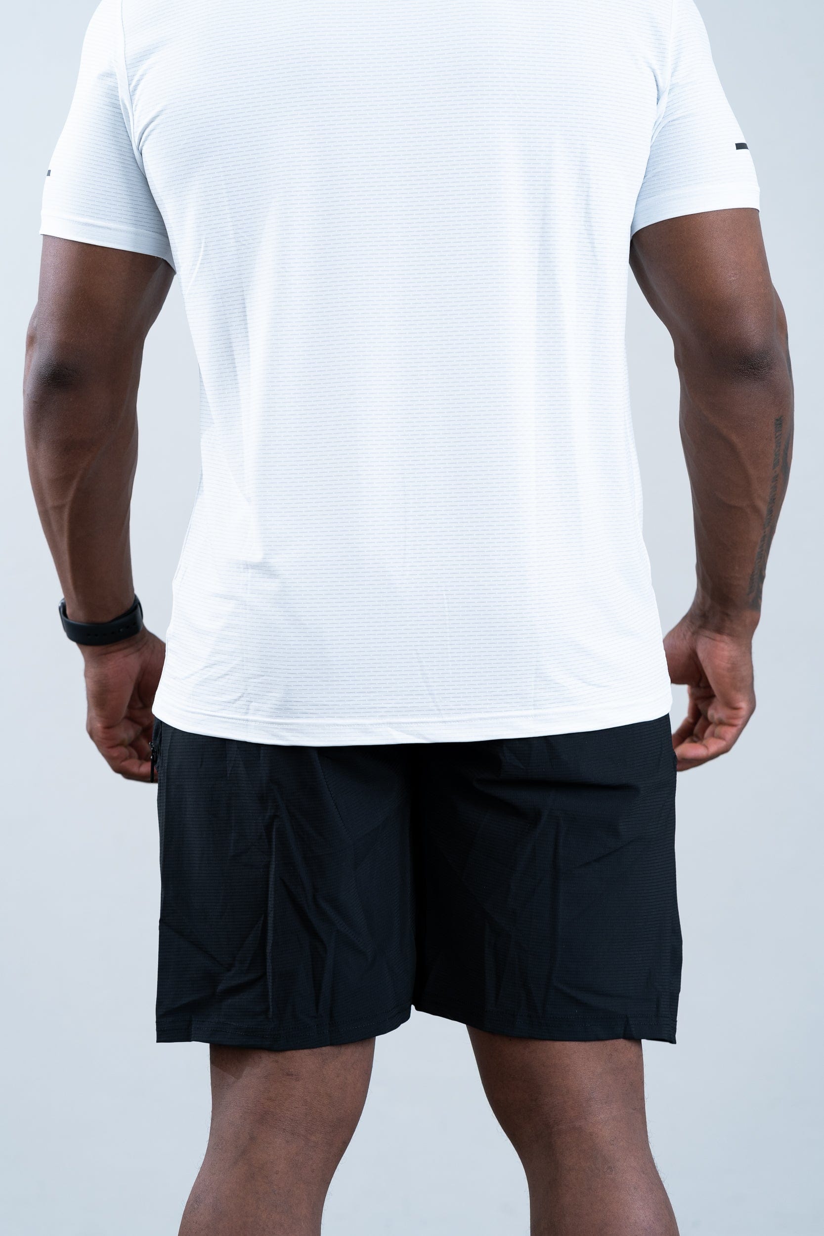athlete wearing botthms white sport t-shirt - clear rear view