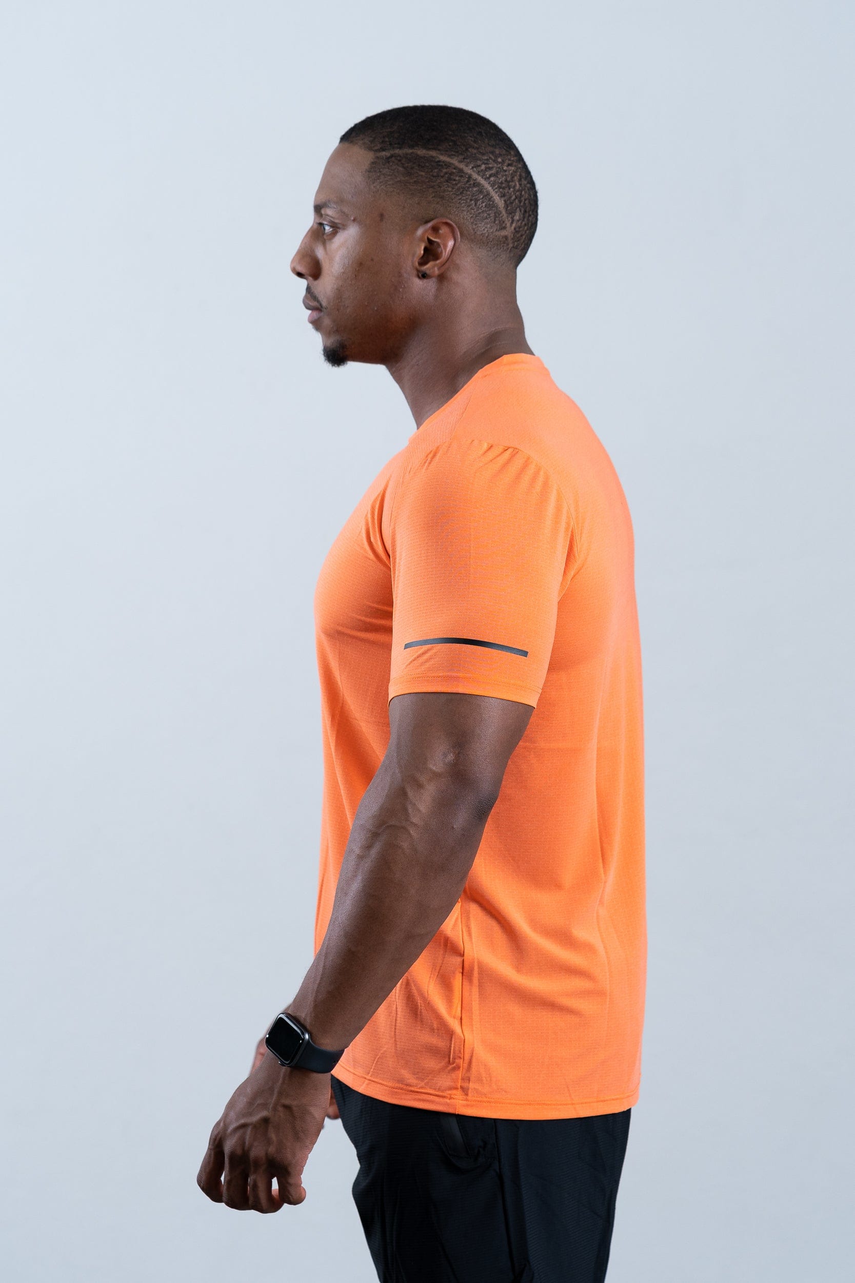 athlete wearing botthms orange sport t-shirt - clear left view