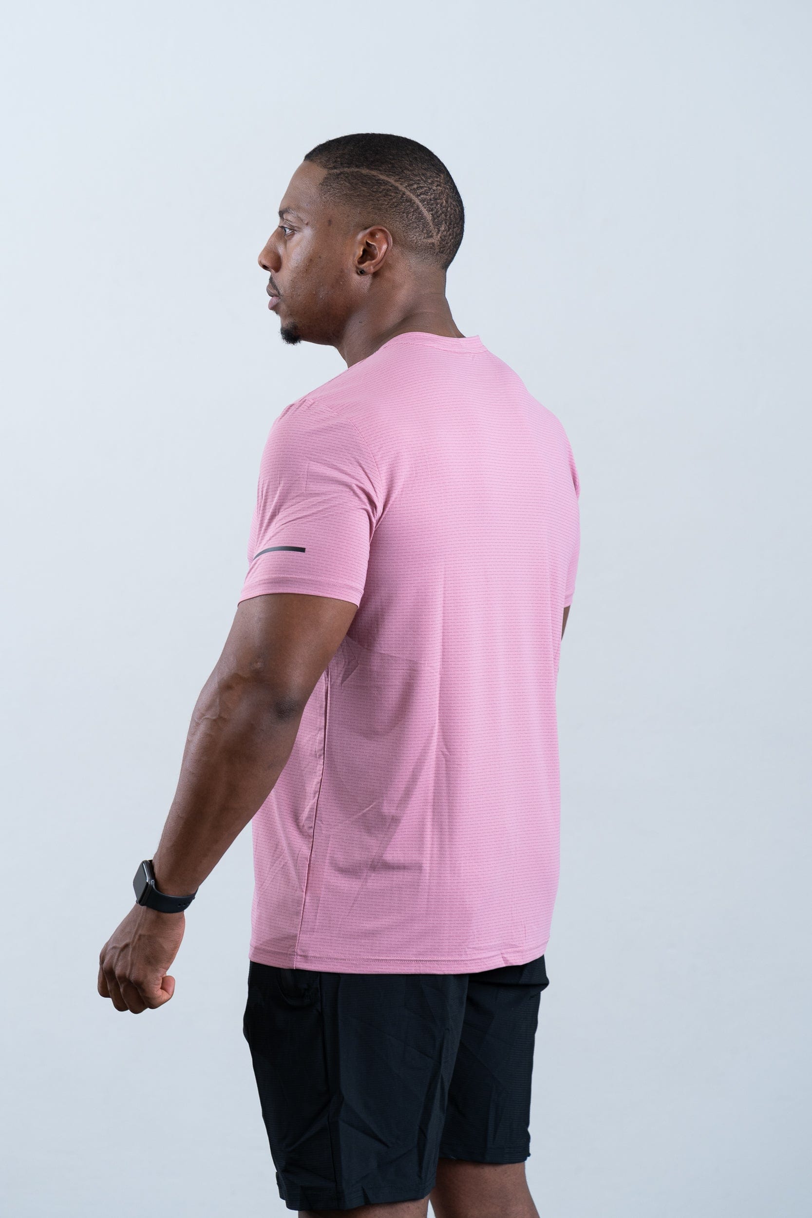 athlete wearing botthms pink sport t-shirt- rear left view