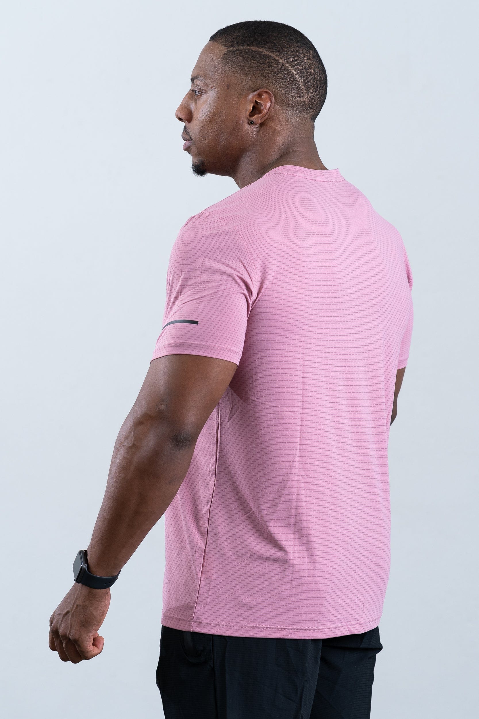 athlete wearing botthms pink sport t-shirt- rear left view