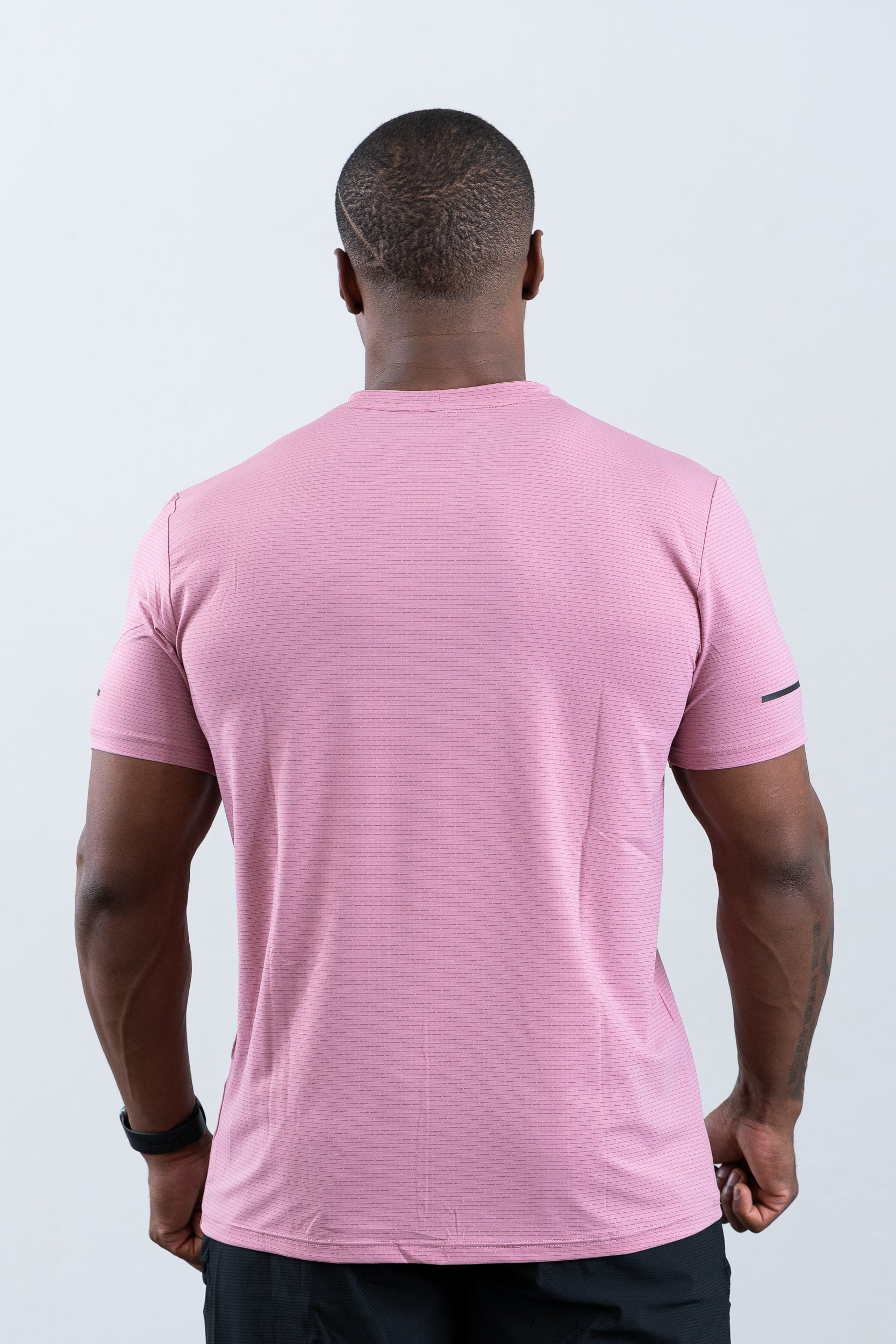 athlete wearing botthms pink sport t-shirt - closeup rear view