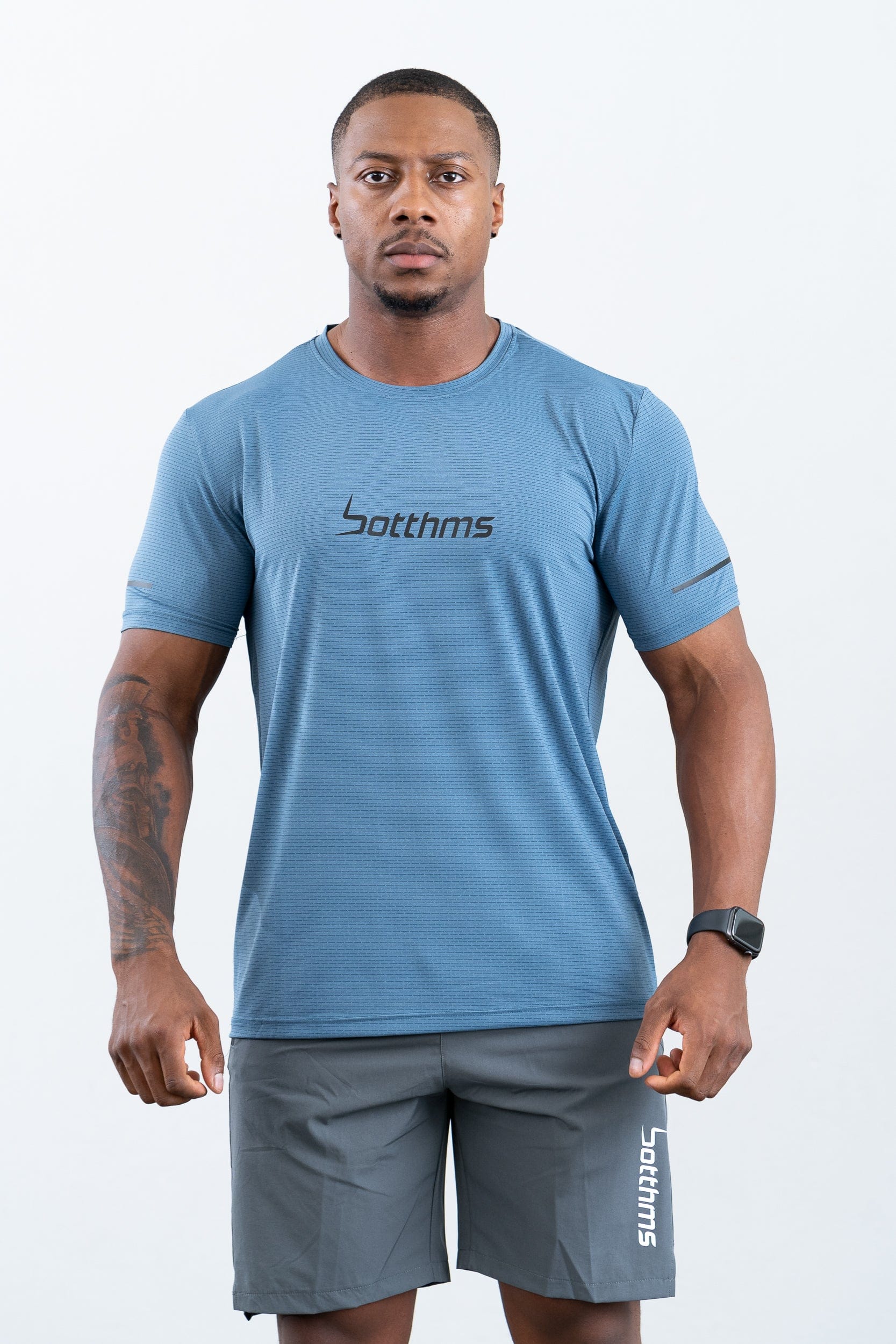 athlete wearing botthms blue sport t-shirt- front view