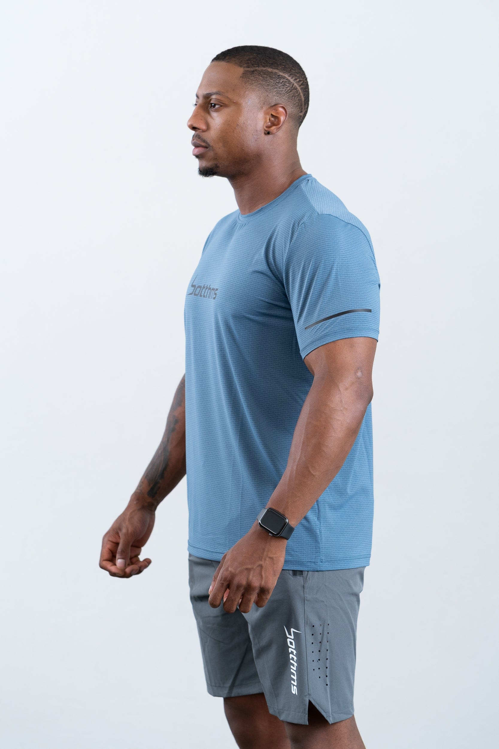 athlete wearing botthms blue sport t-shirt- left view