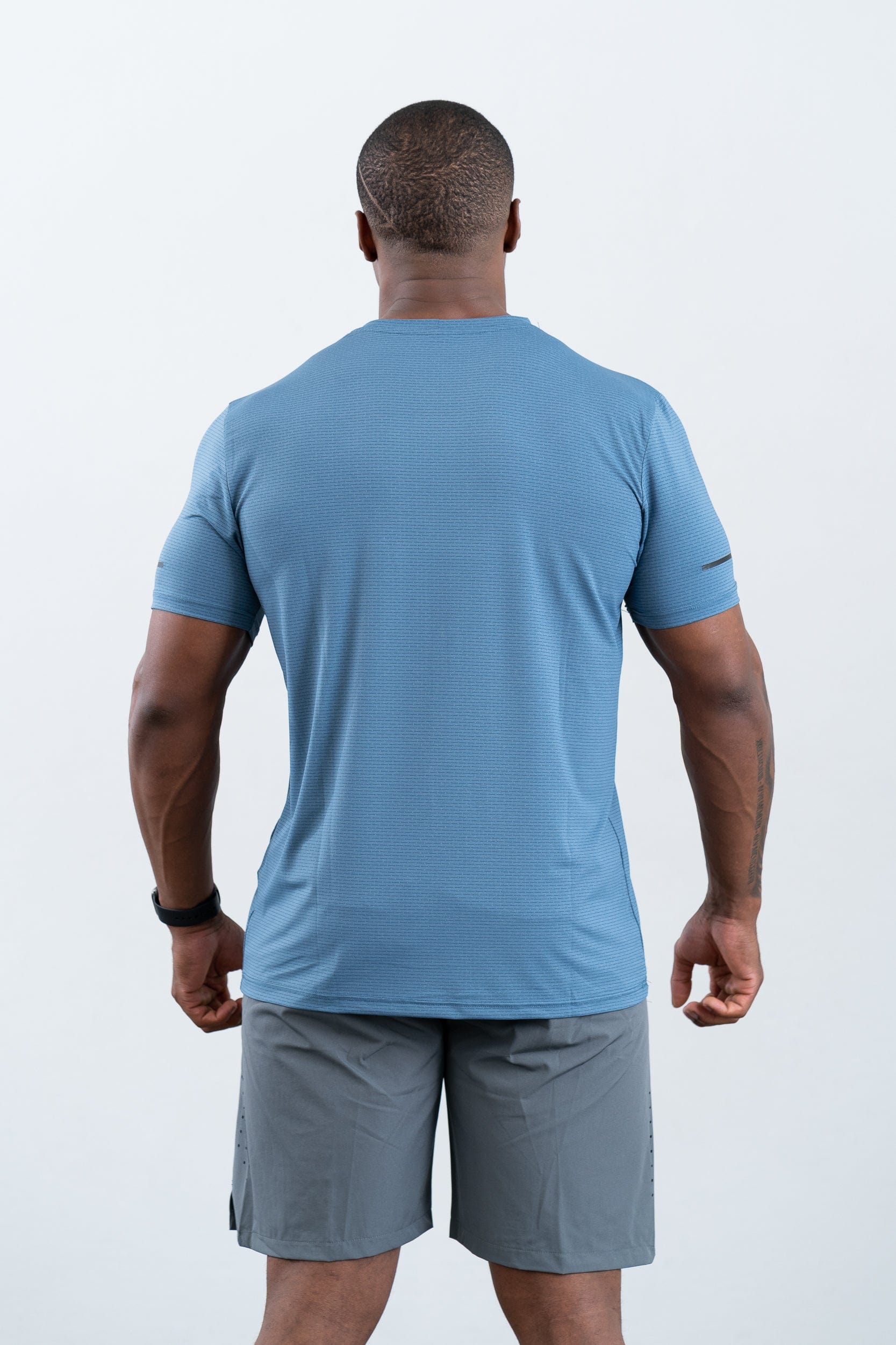 athlete wearing botthms blue sport t-shirt- rear view
