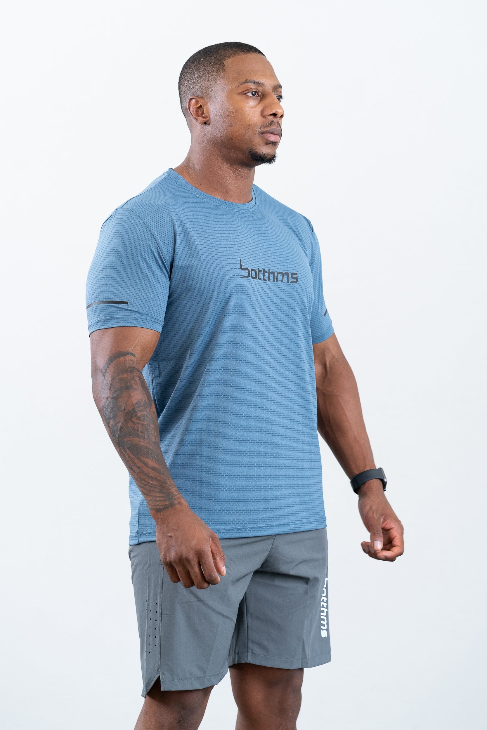 athlete wearing botthms blue sport t-shirt- right front view
