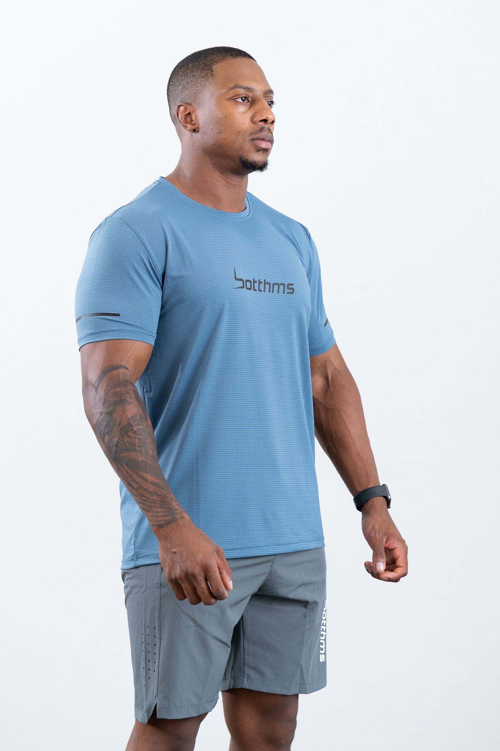 athlete wearing botthms blue sport t-shirt- right front view