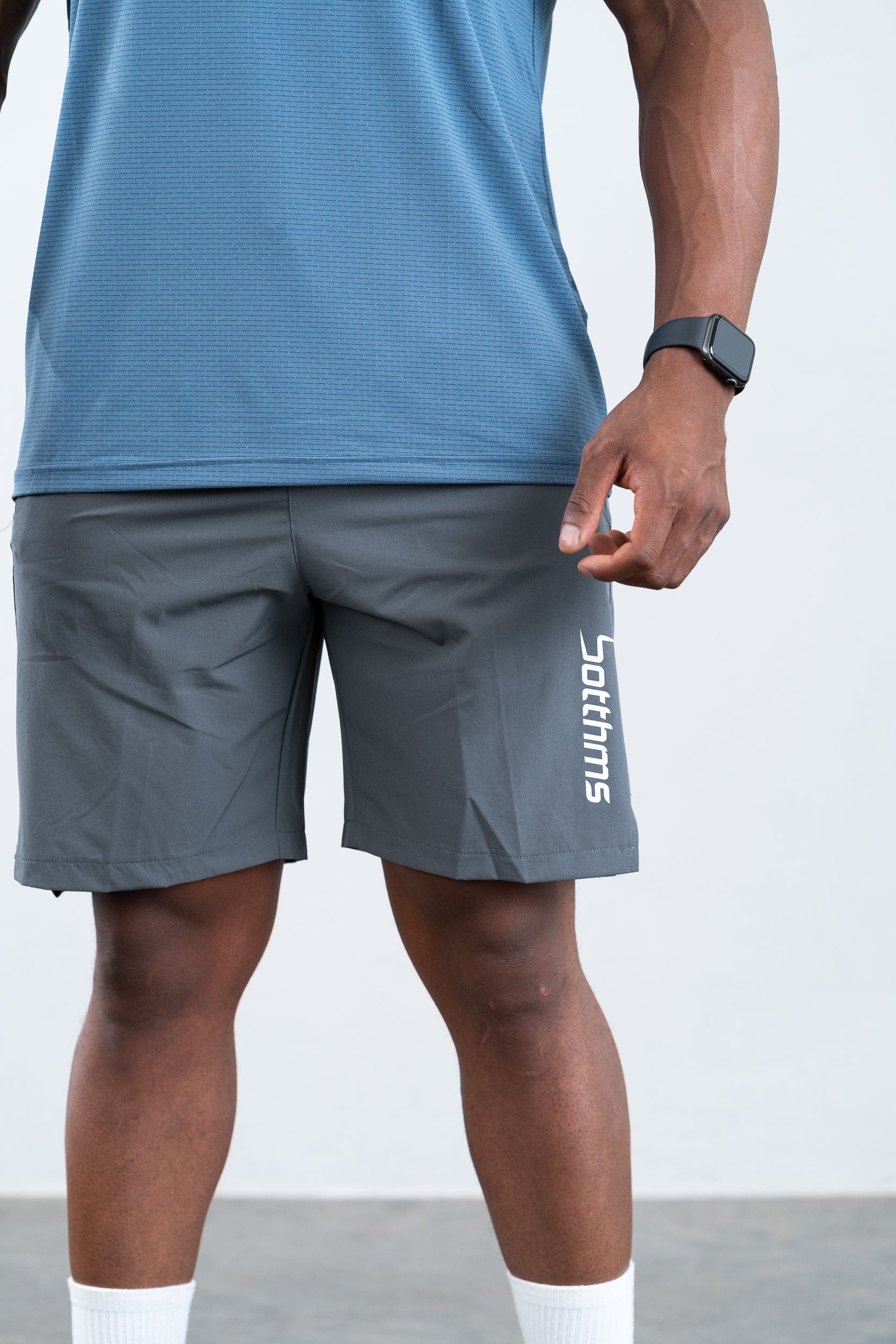 athlete wearing botthms blue sport t-shirt- front below closeup view