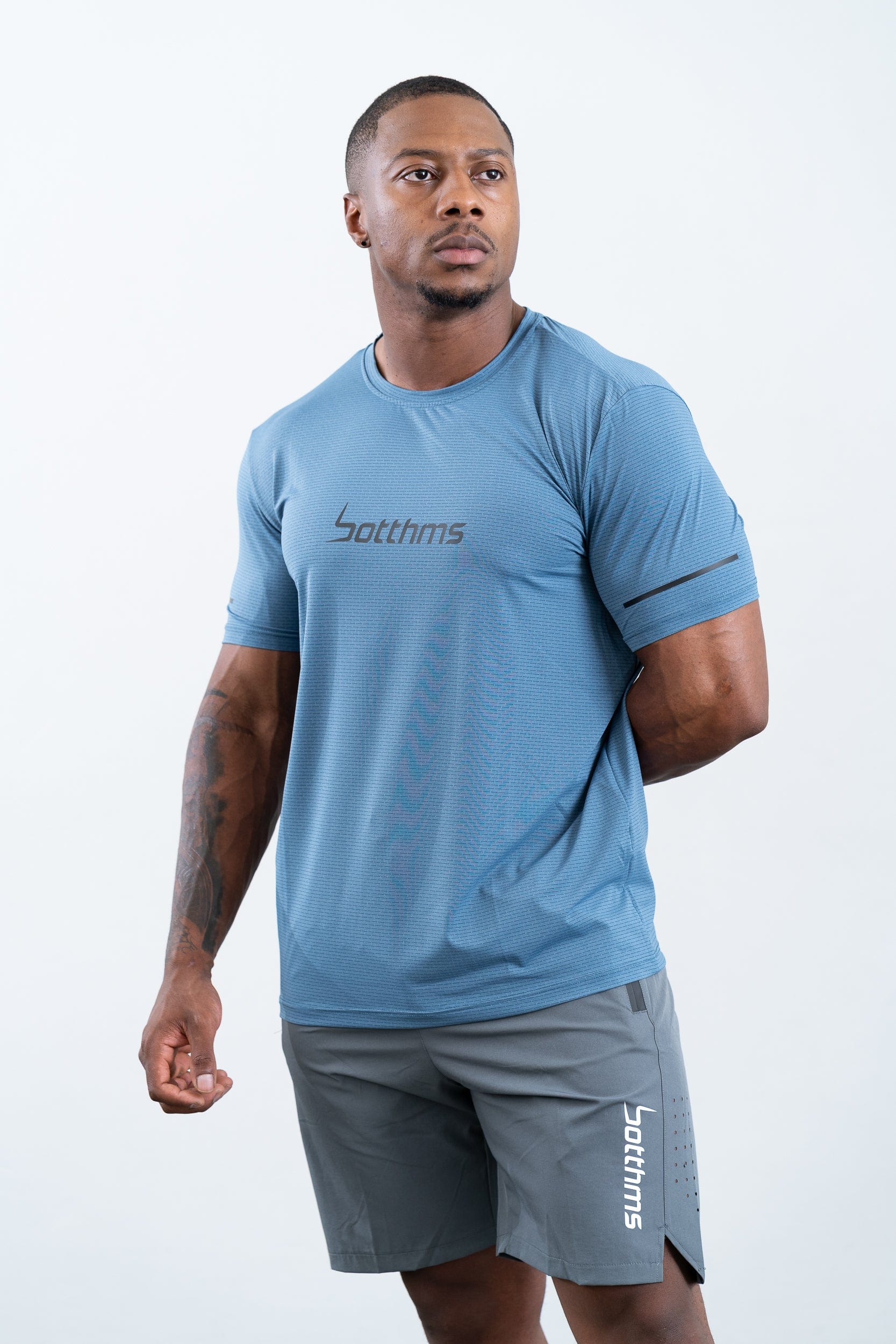 athlete wearing botthms blue sport t-shirt- front view