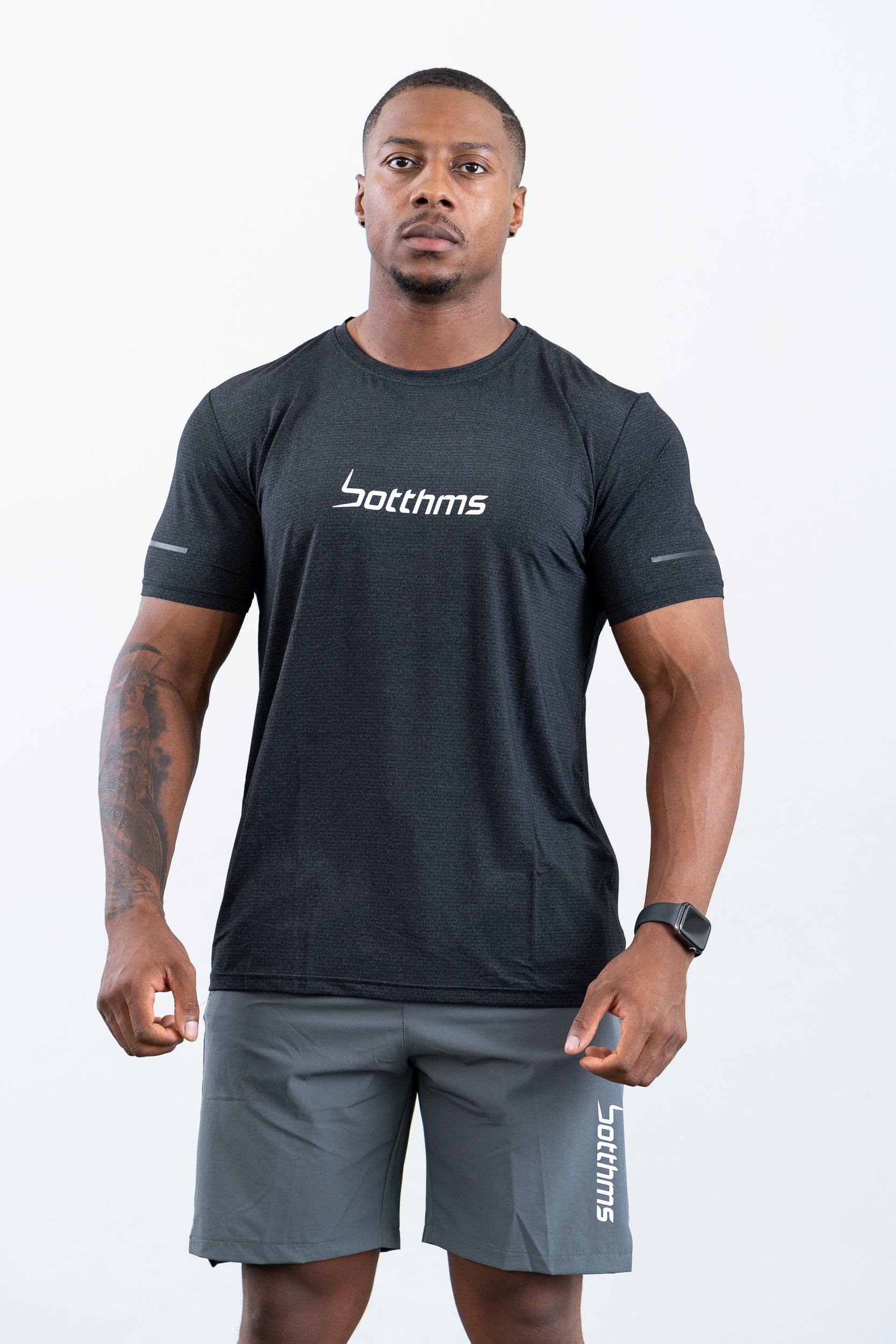 man standing wearing botthms black sport t-shirt- front face view